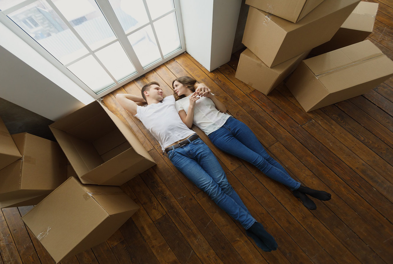 Happy but tired young couple lie on the floor of their new home. top view; Shutterstock ID 795925480; Projet: Pictet