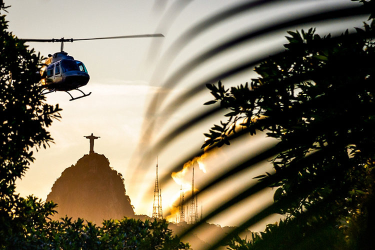 Helicopter flying in the sky with Christ The Redeemer statue in the background, Corcovado, Rio de Janeiro, Brazil