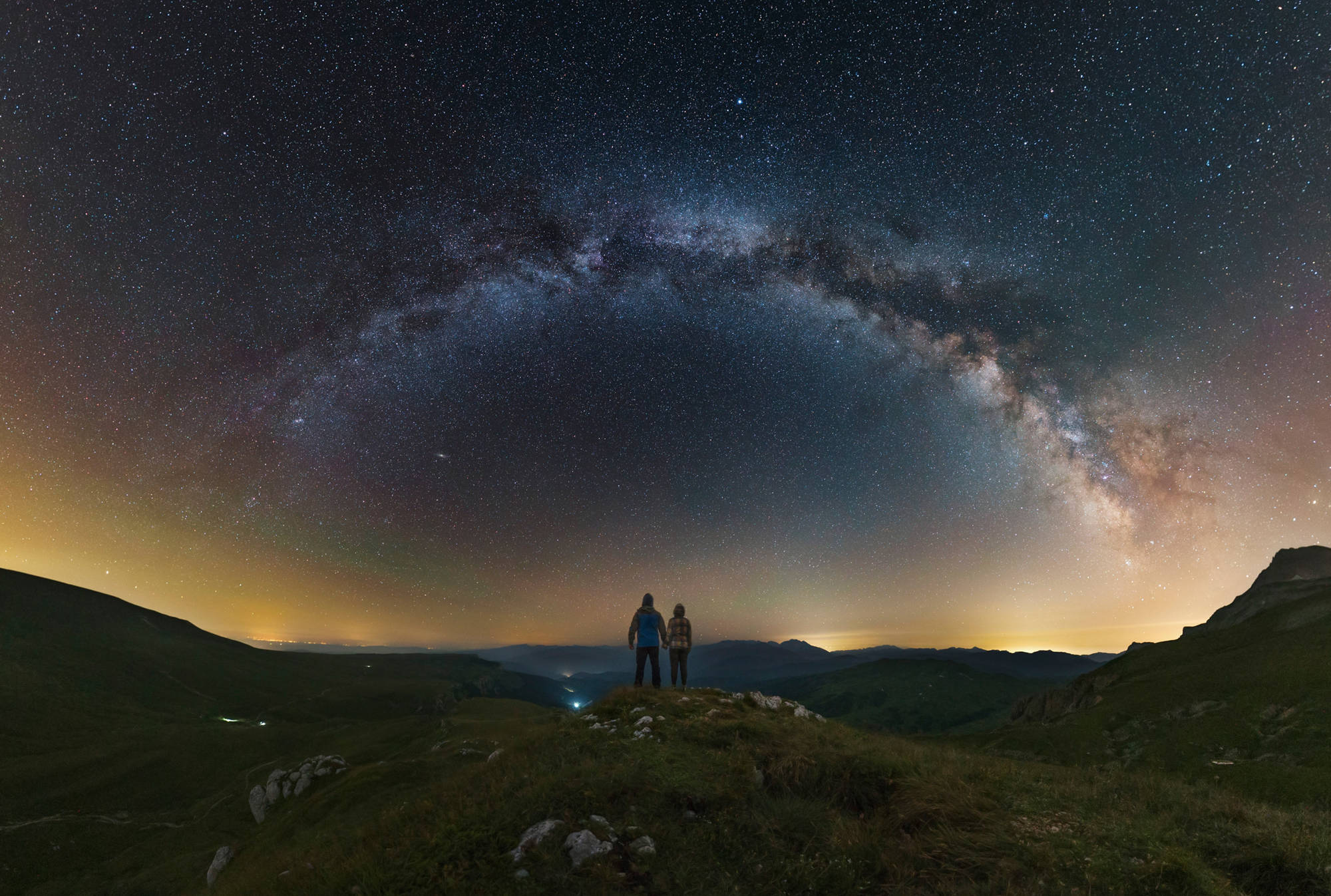A couple gazing at the Milky Way from atop the Lago-Naki plateau overlooking Russia.

