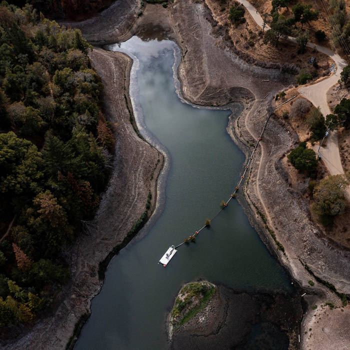 An aerial view of dry ground at the edge of a lake during a drought. Photographer: David Paul Morris/Bloomberg