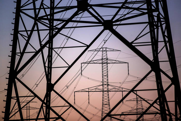 High voltage electricity transmission towers at dusk. Photographer: Krisztian Bocsi/Bloomberg
