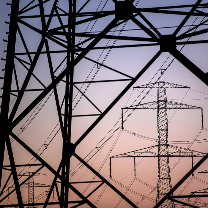 High voltage electricity transmission towers at dusk. Photographer: Krisztian Bocsi/Bloomberg